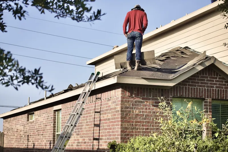Professional roofer working on a residential roof in Chesapeake City
